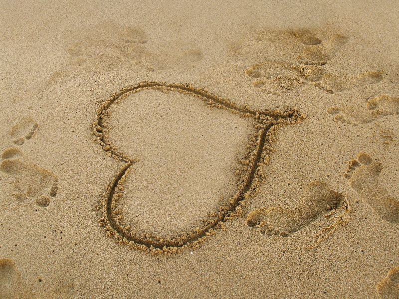 Love Heart in Sand Beach Background