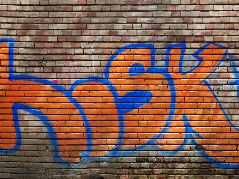 Orange Bricks Wall With Bright Graffiti Texture